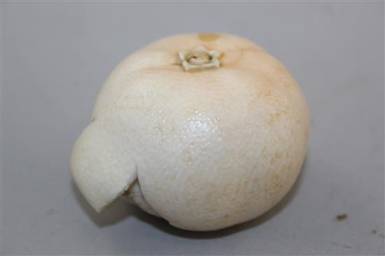 A Japanese ivory model of a partially peeled satsuma, early 20th century, 6.5cm, colour faded, age cracks